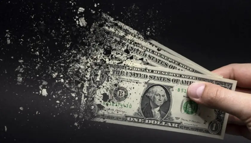 Inflation, dollar hyperinflation. Banner with black background. One dollar bill is sprayed in the hand of a man on a black background. The concept of decreasing purchasing power, inflation.